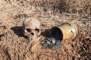 a hoard of ancient coins in a jug found during a search at an old settlement using a metal...