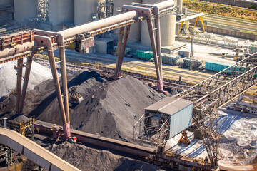 Top view of a cement plant. Workshops and compressors, equipment, metallurgy. Slag and sand and...