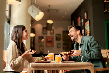 Enjoying a delightful brunch together at a cozy cafe on a sunny afternoon in the heart of the city