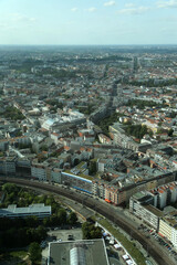 A panoramic view of Berlin's urban landscape featuring historic architecture and modern infrastructure under a clear sky at dusk