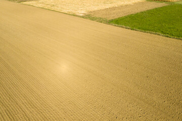 Aerial view of textured agricultural fields showcasing different colors and patterns, reflecting the beauty of farmland.