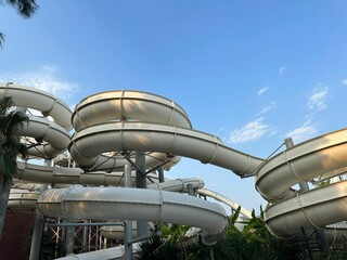 Water slide against blue sky, low angle view