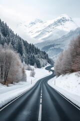 Fototapeta premium A snow covered road with a mountain in the background. The road is empty and straight. The snow is white and the sky is cloudy