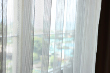 Window with light tulle in hotel room, closeup