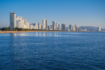 Fototapeta premium Resort city of Nha Trang in Vietnam with a sandy beach by the sea and skyscrapers of hotels in summer