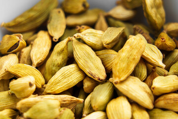 Fragrant organic cardamom spice seeds close up. Macro shot
