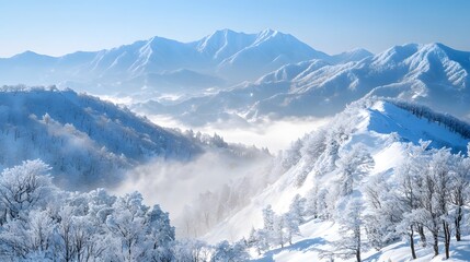 Obraz premium A snow-covered mountain range under a clear blue sky, with white clouds swirling around the peaks.