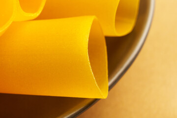 Large tubes of dry uncooked Italian gluten free pasta. Macro shot