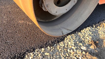 Asphalt paving roller. Road roller laying fresh asphalt, working on the new road construction site