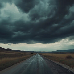 Fototapeta premium Driving on the road, A wide road with dark storm clouds overhead, leading to an unknown destination. The sky is filled with ominous black and gray hues, creating the perfect backdrop for adventure