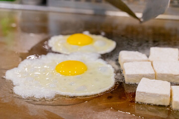 The fragrant Teppanyaki tofu is being prepared for each dish