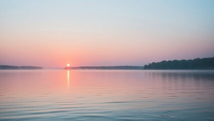 Obraz premium Serene sunrise over tranquil lake with golden light reflections.