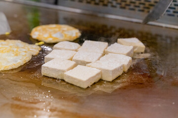 The fragrant Teppanyaki tofu is being prepared for each dish