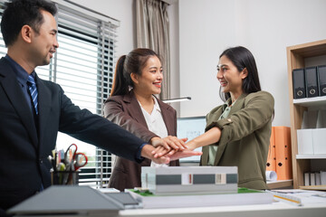 Real Estate Agents Collaborate on Marketing Strategies in Modern Office Setting