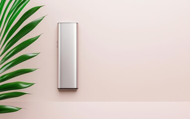 A stainless steel portable charger mockup, placed on a minimalist desk next to a sleek smartphone