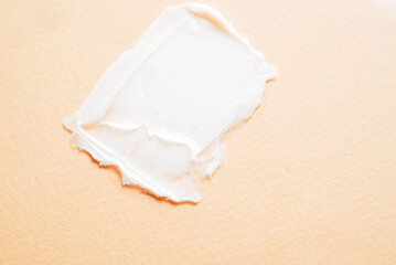 Sample of cosmetic cream on a beige background. Texture of cosmetic skin care product