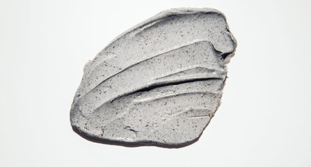 Close-up of a smear of a skin scrub on a white background. Texture of skin care cosmetic product. Cleansing and exfoliating your skin.