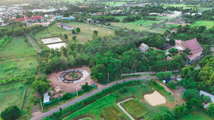 A Thai temple in Prakhon Chai district is surrounded by a verdant garden.