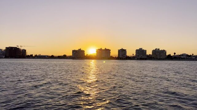 Larnaca Cyprus, view from the boat of the coast at sunset. Hotels and buildings on the beach in Larnaca. Boat ride in Cyprus. Boat tour to the Zenobia shipwreck.