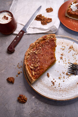 Slices of pumpkin pie on a ceramic plate on a gray background. View from above