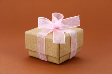 Square cardboard gift box with bow