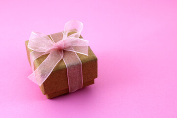 Square cardboard gift box with beautiful bow