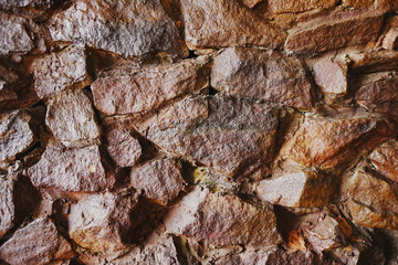 Wet brown grey embossed stone wall for abstract background and texture for interior or exterior design. Beautiful patterns, space for work, banner, wallpaper close up.
