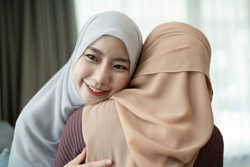 Two muslim women embracing together