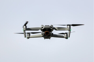 A Drone Hovering Against a Clear Blue Sky