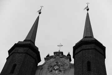 two towers and religious symbols on the church building, black and white photo, Oliwa, Poland