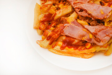 A delicious snack of ham and potatoes on a white plate.