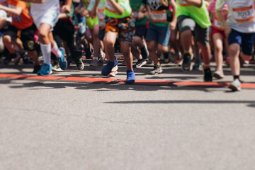 Children marathon runners crowd, young teen sportsmen participants start running in the city streets, crowd of kids joggers in motion, kid group athletes outdoor run, family competition in summer day