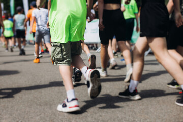 Children marathon runners crowd, young teen sportsmen participants start running in the city...