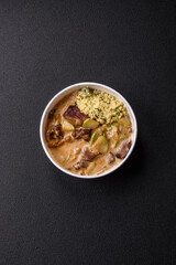 Bowl of food with beef, bulgur, tomatoes, zucchini and sauce