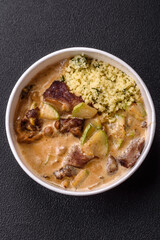Bowl of food with beef, bulgur, tomatoes, zucchini and sauce