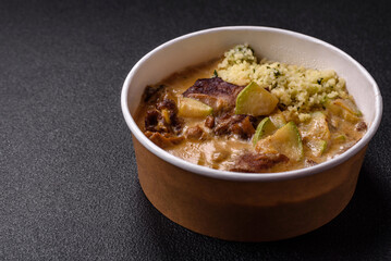 Bowl of food with beef, bulgur, tomatoes, zucchini and sauce