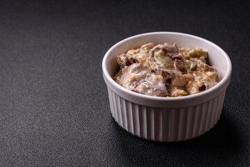 Bowl of food with beef, bulgur, tomatoes, zucchini and sauce