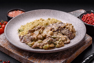 Bowl of food with beef, bulgur, tomatoes, zucchini and sauce