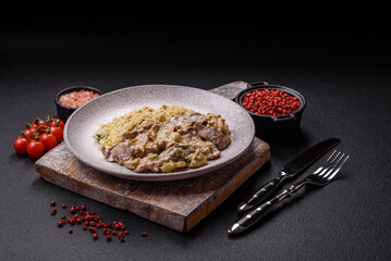 Bowl of food with beef, bulgur, tomatoes, zucchini and sauce