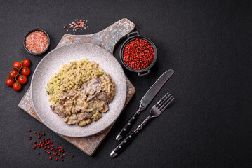 Bowl of food with beef, bulgur, tomatoes, zucchini and sauce