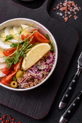 Salad with tuna pieces, boiled egg, cherry tomatoes, lettuce