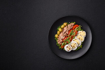 Salad with tuna pieces, boiled egg, cherry tomatoes, lettuce