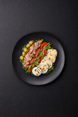 Salad with tuna pieces, boiled egg, cherry tomatoes, lettuce