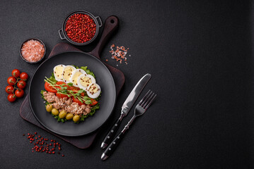 Salad with tuna pieces, boiled egg, cherry tomatoes, lettuce