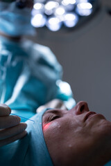 Middle-aged woman undergoing a face surgery in a private clinic.