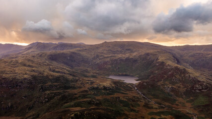 Naklejka premium Aerial view of Easedale Tarn above Grasmere in The lake District National Park at sunset