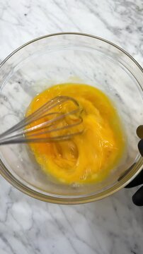whisking eggs for food preparation using wire whisker.