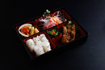 Tonkatsu and sashimi bento set japanese food isolate in black background