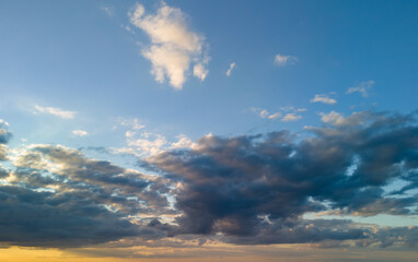 A beautiful sky with fluffy clouds at sunset, showcasing a blend of warm and cool tones