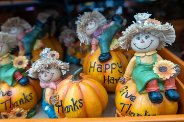 Cheerful scarecrow figurines on decorative pumpkins, each with an inspiring messages. Thanksgiving gifts.